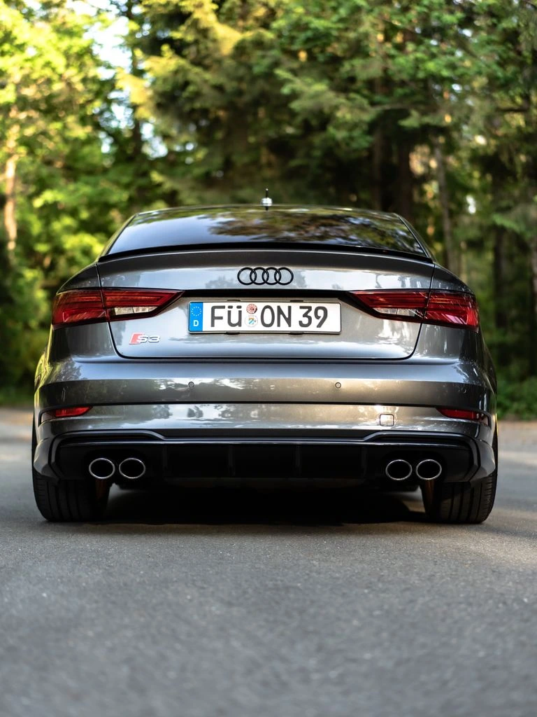 A 2022 Audi RS3 on a lift showing a Whipple supercharger install.